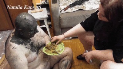 Feeding, pushing down shit in the pigs throat
