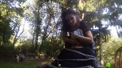 The bound slave was dominated outdoors.
