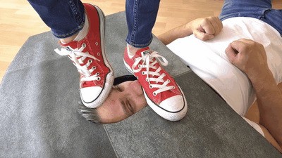Trampling his face under converse and socks