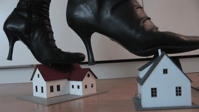 Model railway houses under sexy boots