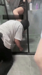 Thumbnail of 2 Hot Tattooed Mistresses Pour Pee from Glass onto Their Feet Then Command the Toilet Slave to Lick